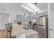 Updated kitchen with stainless steel appliances, a breakfast bar, ample counter space, and natural light from skylights at 2675 S Deframe Cir, Lakewood, CO 80228