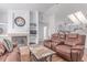 Cozy living space featuring a fireplace, comfortable seating, and an open layout with vaulted ceilings at 2675 S Deframe Cir, Lakewood, CO 80228