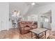 Open concept living space showcasing a fireplace, vaulted ceilings, and seamless flow into the dining and kitchen areas at 2675 S Deframe Cir, Lakewood, CO 80228