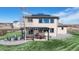 Landscaped backyard featuring an outdoor dining area, fire pit, pergola, and solar panels at 12701 Strawberry Cir, Longmont, CO 80503