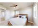 Bright bedroom featuring a ceiling fan, natural light, and a comfortably furnished bed at 12701 Strawberry Cir, Longmont, CO 80503