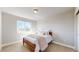 Bedroom featuring a cozy bed, soft natural light from the window, and plush carpet flooring at 12701 Strawberry Cir, Longmont, CO 80503