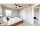 Cozy bedroom with a ceiling fan, closet, and a glimpse into an exercise area at 12701 Strawberry Cir, Longmont, CO 80503