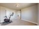 Carpeted exercise area with natural light and a stationary bike with a mounted screen at 12701 Strawberry Cir, Longmont, CO 80503