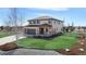 Charming exterior with manicured lawn, three-car garage, and lovely landscaping at 12701 Strawberry Cir, Longmont, CO 80503