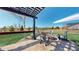 Outdoor fire pit with Adirondack chairs on a stone paver patio and a view of the lawn at 12701 Strawberry Cir, Longmont, CO 80503
