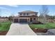 Inviting two-story home with an attached three-car garage and a long driveway at 12701 Strawberry Cir, Longmont, CO 80503