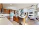 Open kitchen with an island, stainless appliances, and hardwood floors at 12701 Strawberry Cir, Longmont, CO 80503