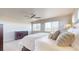 Light-filled main bedroom featuring a ceiling fan, dresser, and plenty of natural light at 12701 Strawberry Cir, Longmont, CO 80503