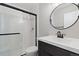 Bathroom featuring an updated shower with black trim and a modern vanity at 10913 W 67Th Pl, Arvada, CO 80004