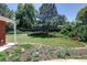 Serene backyard featuring lush greenery, mature trees, and privacy fencing at 2900 S Golden Way, Denver, CO 80227