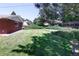 Spacious backyard with mature landscaping and a charming brick home exterior at 2900 S Golden Way, Denver, CO 80227