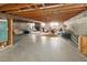Unfinished basement offers a large open space with exposed beams and a brick fireplace at 2900 S Golden Way, Denver, CO 80227