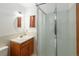Clean bathroom featuring a shower, sink, and window, providing essential amenities in a compact space at 2900 S Golden Way, Denver, CO 80227