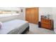 Cozy bedroom features ample closet space, a dresser, and a large window at 2900 S Golden Way, Denver, CO 80227