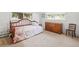 Bright bedroom features natural light, a wood bed frame, and a wooden dresser, creating a peaceful retreat at 2900 S Golden Way, Denver, CO 80227