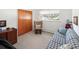 Cozy bedroom with a comfortable chair, a plaid loveseat, and a window offering natural light at 2900 S Golden Way, Denver, CO 80227