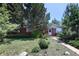 Charming brick home with a lush front lawn, mature trees, and a welcoming walkway at 2900 S Golden Way, Denver, CO 80227