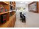 Dedicated home office with built-in wooden shelving, a comfortable desk, and a window for natural light at 2900 S Golden Way, Denver, CO 80227