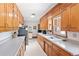 Bright kitchen featuring wooden cabinets, ample counter space, and essential appliances for convenient meal preparation at 2900 S Golden Way, Denver, CO 80227
