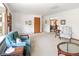 Open living room with a neutral carpet, blue armchair, wood furniture, and natural light at 2900 S Golden Way, Denver, CO 80227
