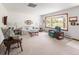 Inviting living room featuring a bay window, neutral carpet, and traditional decor at 2900 S Golden Way, Denver, CO 80227