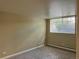 Bedroom showing plush carpeting, a bright window, and neutral walls for a calm, peaceful space at 1390 Emerson St # 107, Denver, CO 80218