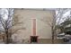 View of the front facade with trees lining the front and a large building with an updated entrance at 1390 Emerson St # 107, Denver, CO 80218