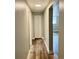 Hallway features updated flooring and fresh paint, leading to multiple rooms for easy access at 1390 Emerson St # 107, Denver, CO 80218