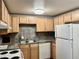 Classic kitchen features stainless steel appliances and earth-toned backsplash for a cozy cooking space at 1390 Emerson St # 107, Denver, CO 80218
