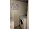 The laundry room has clean, white appliances and instructions in both English and Spanish at 1390 Emerson St # 107, Denver, CO 80218