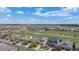 A scenic aerial view of a neighborhood with mature trees, green spaces and a golf course at 11788 Mill Valley St, Parker, CO 80138