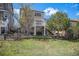 Beautiful backyard featuring a two-story home with a deck, mature trees, and a well-maintained lawn at 11788 Mill Valley St, Parker, CO 80138