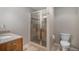 Bathroom featuring a glass enclosed shower and tile flooring at 11788 Mill Valley St, Parker, CO 80138