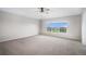 Spacious carpeted primary bedroom with large window offering exterior view and ceiling fan at 11788 Mill Valley St, Parker, CO 80138