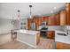 Modern kitchen boasts stainless steel appliances, a center island, and warm wood cabinets at 11788 Mill Valley St, Parker, CO 80138