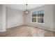Bright and airy room with large window, hardwood floors, neutral paint, and modern light fixture at 11788 Mill Valley St, Parker, CO 80138