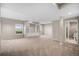 Spacious living room with neutral carpet, built-in shelving, and abundant natural light at 11788 Mill Valley St, Parker, CO 80138