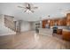 Open-concept living area seamlessly connects to a modern kitchen with stainless appliances and hardwood floors at 11788 Mill Valley St, Parker, CO 80138
