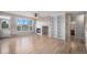 Open living room boasts a cozy fireplace, built-in bookshelves, hardwood floors, and a view of the deck at 11788 Mill Valley St, Parker, CO 80138