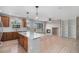 Open-concept living space with hardwood floors, fireplace, and a kitchen with a center island and stainless appliances at 11788 Mill Valley St, Parker, CO 80138