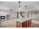 Open-concept space with hardwood floors, built-in shelves, fireplace, and a kitchen with a center island at 11788 Mill Valley St, Parker, CO 80138