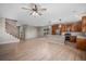 Open-concept living space with hardwood floors, a staircase, and a modern kitchen with stainless steel appliances at 11788 Mill Valley St, Parker, CO 80138