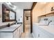 Functional bathroom and laundry room features updated fixtures and ample storage space at 2525 S Dayton Way # 1003, Denver, CO 80231