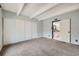 Bedroom featuring carpet, a window, closet, and a bathroom at 2525 S Dayton Way # 1003, Denver, CO 80231
