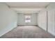 Spacious bedroom with neutral carpet, large window, and ample closet space at 2525 S Dayton Way # 1003, Denver, CO 80231