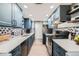 Modern kitchen showcases elegant blue cabinets, quartz countertops, and a stylish backsplash design at 2525 S Dayton Way # 1003, Denver, CO 80231
