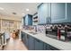 Well-appointed kitchen features blue cabinets, stainless steel appliances, and mosaic backsplash at 2525 S Dayton Way # 1003, Denver, CO 80231
