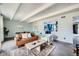Open living area with hardwood floors, neutral tones, modern decor, and a kitchen view at 2525 S Dayton Way # 1003, Denver, CO 80231