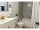 Modern bathroom with vanity, toilet, tub, shower featuring gray tiles and gold hardware at 2218 Coronado N Pkwy # B, Denver, CO 80229